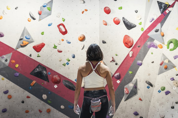 Unrecognizable woman ready for practice rock climbing on artificial wall indoors. - obrazy, fototapety, plakaty