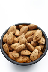 Fresh almonds in the skin on white background