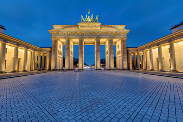 The famous Brandenburg Gate in Berlin illuminated in the early morning © elxeneize