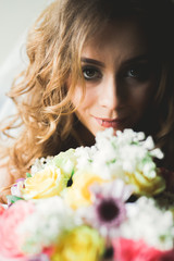 Naklejka premium Portrait of beautiful bride with fashion veil at wedding morning. Wedding dress.