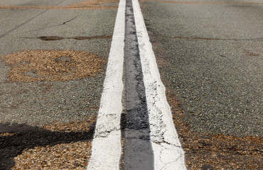 Asphalt road with marking lines white stripes. Two solid lines