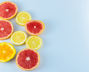 Fototapeta na wymiar Sliced citrus fruits on white background with copy space