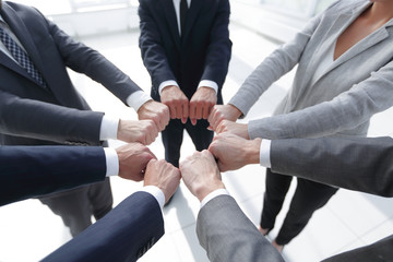 closeup.business people show a circle of hands.
