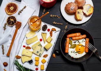 cheese and a round cast-iron frying pan with fried egg