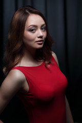 Fashionable young beautiful woman in a red dress