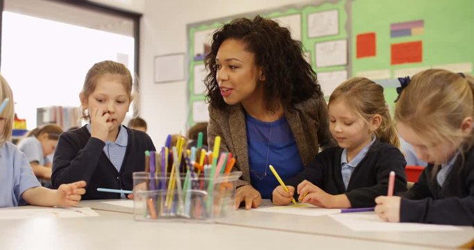 4k, Classroom of young boys and girls during an art class with their teacher. Slow motion.