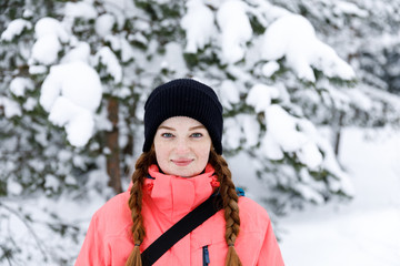Obraz premium Sport style girl portrait in the winter forest. Snow adventure