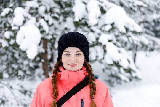 Sport style girl portrait in the winter forest. Snow adventure