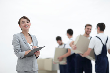 Woman manager holding clipboard on blurred background with mover