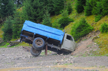 The big truck hit the mountain and got stuck in it