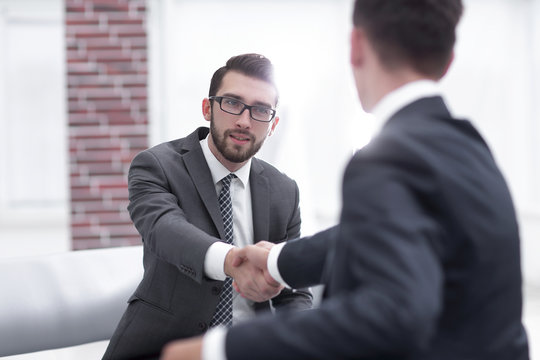 Two colleagues shaking hands after a business meeting
