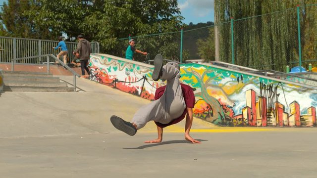 Man breakdancing in the skate park