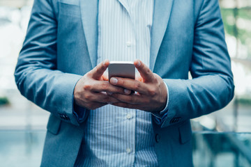 Freelance manager texting message on smartphone