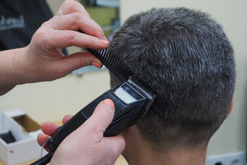 The process of male haircuts in the salon. Close up.
