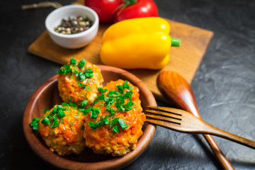 Meatballs with rice and meat in a wooden dish. Place for your text.