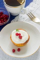 Mini cheesecake with whipped cream and red currant. Rustic style.