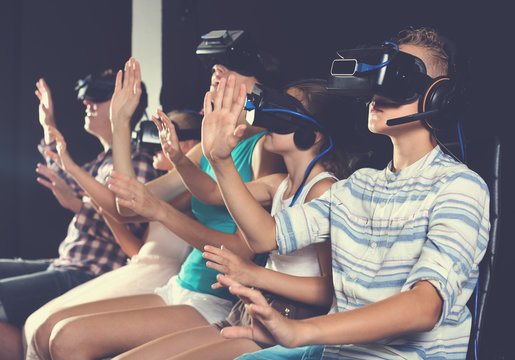 Boy is enjoying movie in virtual reality glasses