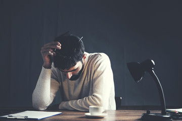 Businessman sitting in an office reacting in shock to the contents