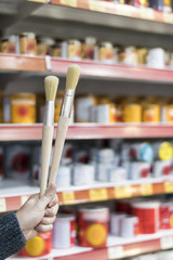 detail of wooden paint brushes in store with great blur