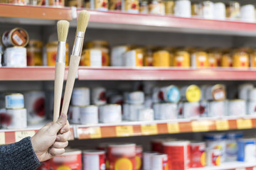 detail of brushes in store held in the hand of a person,