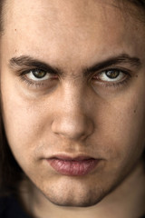 Face and eyes of a young handsome man with expressive eyes closeup