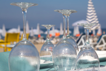 Inverted glasses on the table at the beach cafe