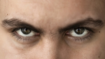 Face and eyes of a young handsome man with expressive eyes closeup