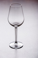 Empty clear wine glass stands on the table