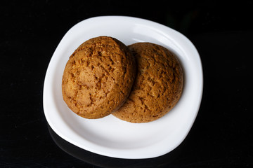 two oatmeal  cookies on a plate