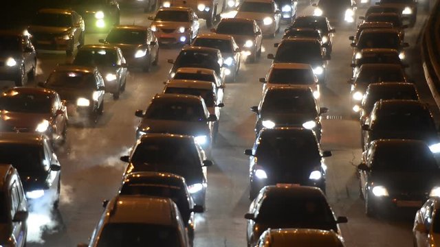 Car traffic jam on the highway. Evening, night, headlight 