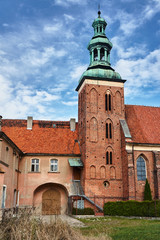 Fototapeta na wymiar Gothic monastery church with belfry in Gniezno.