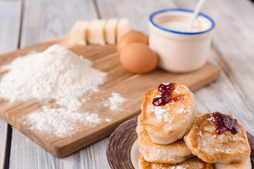 pancakes in a plate with ingredients on a wooden table