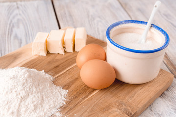 pancakes in a plate with ingredients on a wooden table