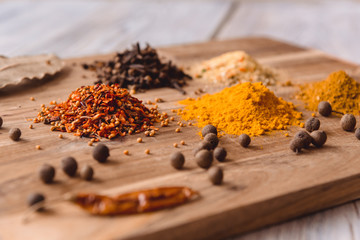 different spices on a white wooden table