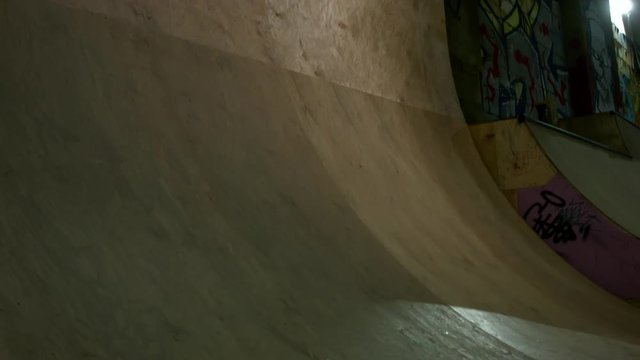 Extreme Sport BMX Athlete Doing Tricks in a Wooden Skateboard Park with Dynamic Lighting in underground, indastrial background