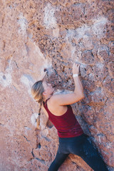Blonde Woman with Braid in Red Tank Top Bouldering Outside