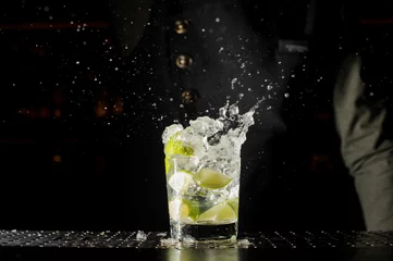 Rolgordijnen Glass filled with splashing fresh Caipirinha cocktail © fesenko
