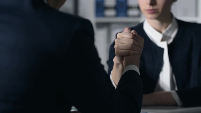 Business people doing arm wrestling