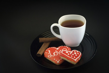 Cake on a black plate and coffee in a white Cup.