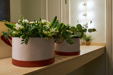 floral arrangement for wedding. Beautiful bright floral composition in hat boxes on table