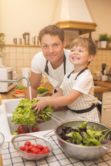 Man and boy washing vegetables before eating