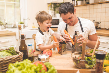 Father is cooking with his son