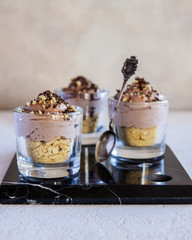 Delicious dessert with ice cream, chocolate mousse and cookies on the table, on a marble Board.