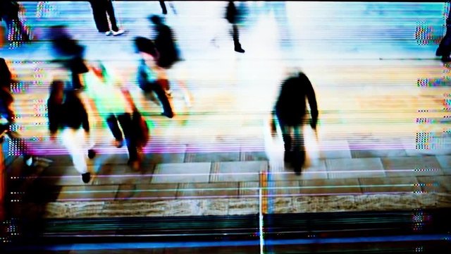timelpase of crowds of commuters at new york's grand central terminal with a filter to mkae it look like security camera footage