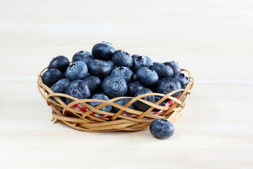 Basket of blueberry on the table.