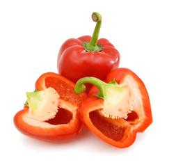 fresh red bell pepper (capsicum) and a cut one on a white background
