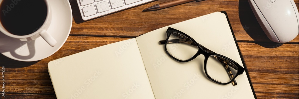 Poster notebook with glasses, coffee, keypad and computer mouse