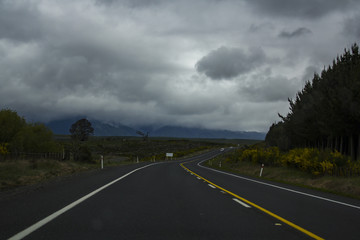  New Zealand scenic Asphalt Road with stormy sky