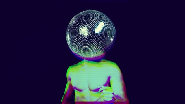 cool muscular man in silver costume with a mirror ball for a head. perfect video for fashion, style, disco, clubs and events