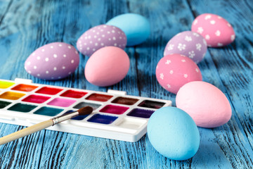 Easter eggs with paint on wooden table, creative concept